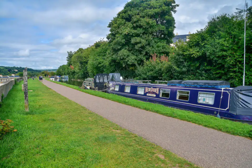 Towpath and moored boats on the Kennet and Avon Canal, Bath