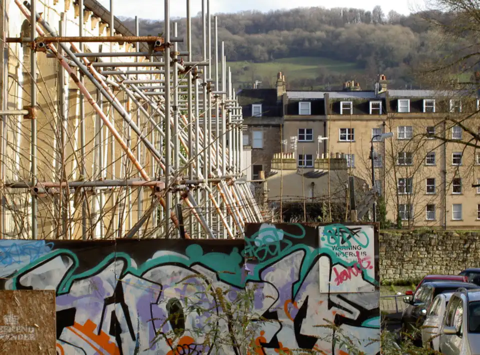 Scaffolding and graffiti with Bath terraces behind