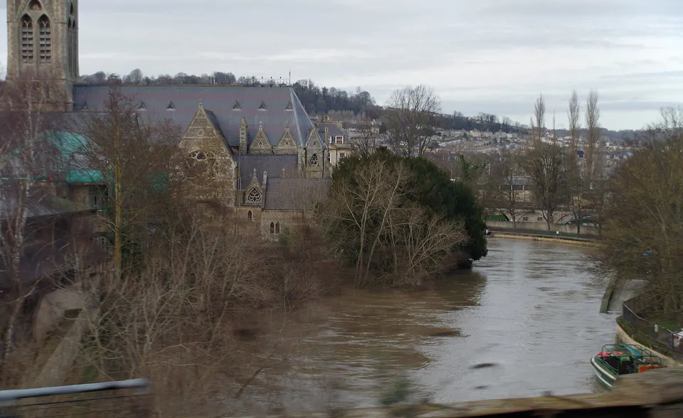 River Avon at a high level beside Bath weirs